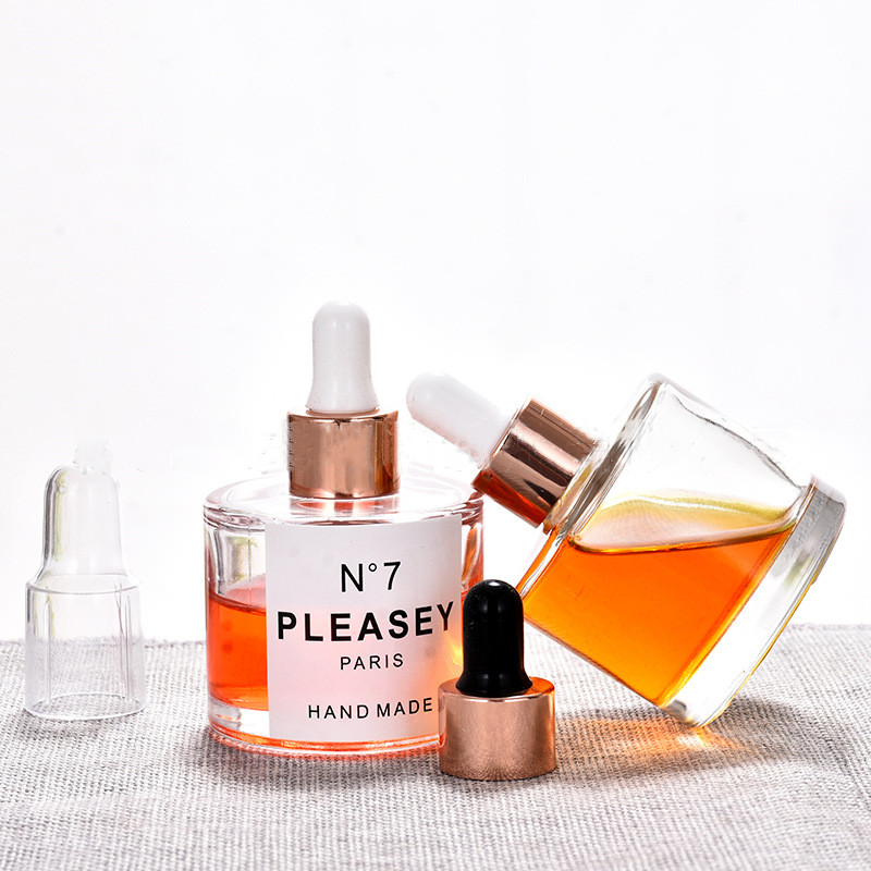 Wholesale 50ml clear glass wide round dropper bottle with gold rose dropper and Silica gel cap for essence oil bottles