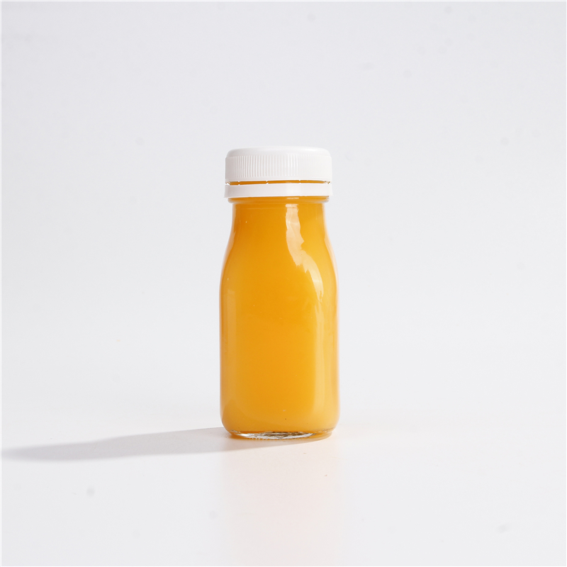 Wholesale 60 ML 2 OZ Juice Glass Beverage Bottle For Milk Juice With Tamper Evident Plastic Lids