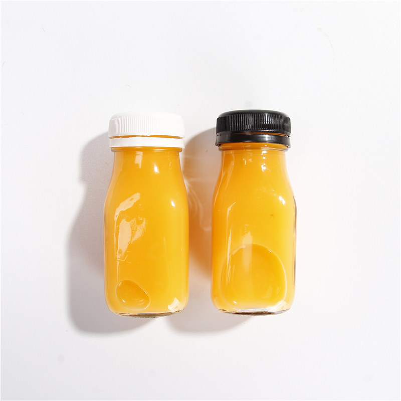Wholesale 60 ML 2 OZ Juice Glass Beverage Bottle For Milk Juice With Tamper Evident Plastic Lids