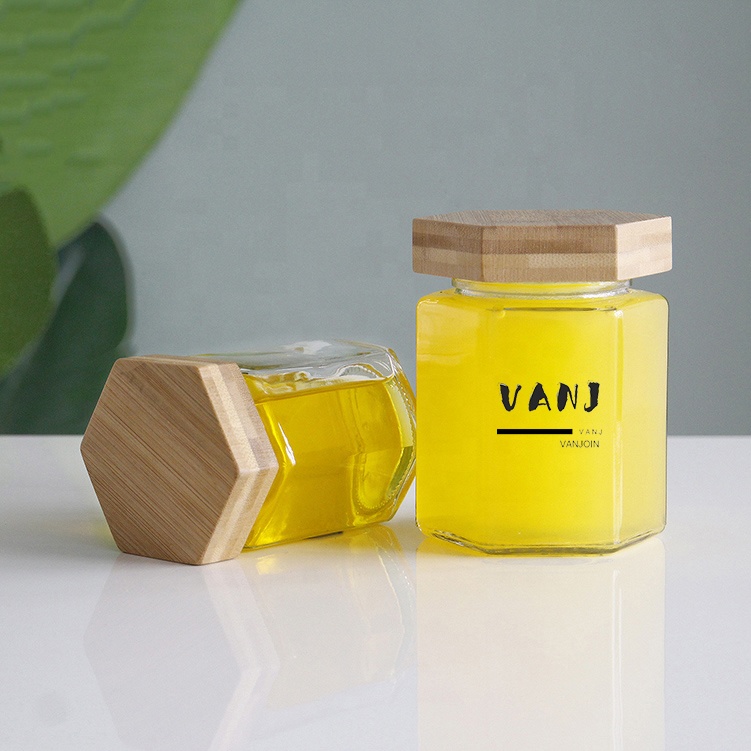 Wholesale Customized Hexagon Shaped 100ml 200ml Empty Clear Hexagonal Honey Jar Glass with Wooden Lid