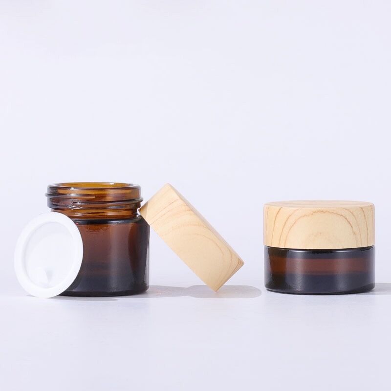 Wholesale amber 5g 10g 30g 50g 100g glass cosmetic jar bottle wood grain cover