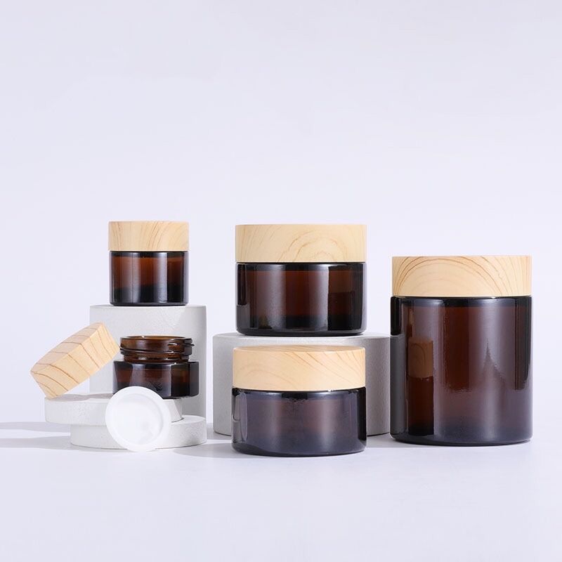 Wholesale amber 5g 10g 30g 50g 100g glass cosmetic jar bottle wood grain cover