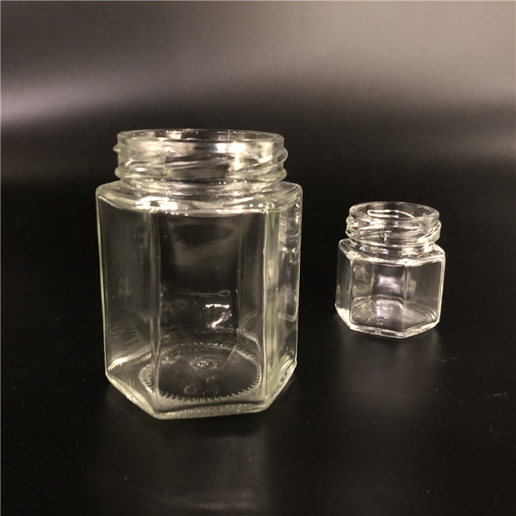 Wholesale cheap hexagon food storage empty honey bee glass jar for canning with metal lid