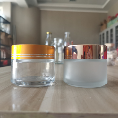 Wholesale cosmetic 4 oz glass container glass cosmetic jars and bottles with black gold plastic caps