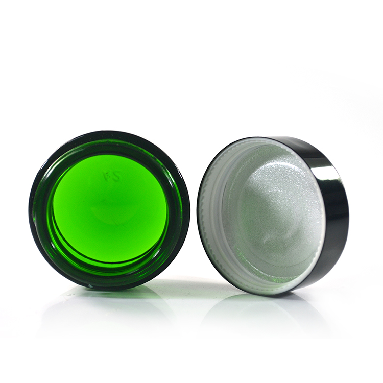Wholesale cosmetic containers cream container 50g green glass cream jar with black anodized aluminum lid