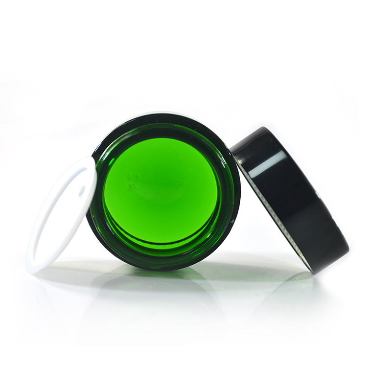 Wholesale cosmetic containers cream container 50g green glass cream jar with black anodized aluminum lid