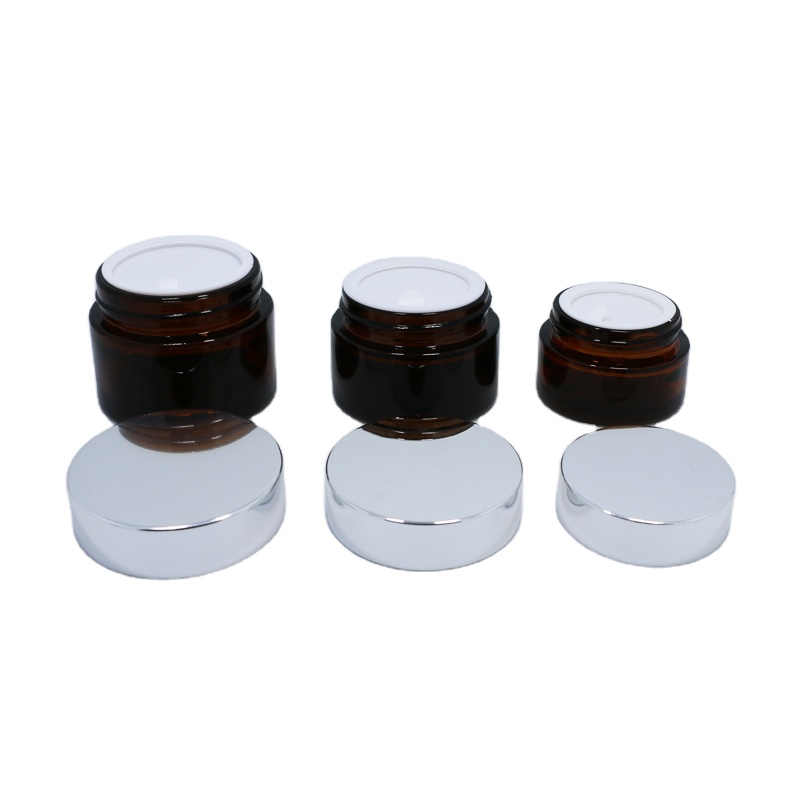 Wholesale cosmetic packaging 20ml 30ml 50ml amber glass jar with silver gold aluminum metal lids black plastic caps in stock