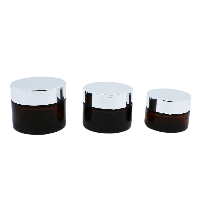 Wholesale cosmetic packaging 20ml 30ml 50ml amber glass jar with silver gold aluminum metal lids black plastic caps in stock