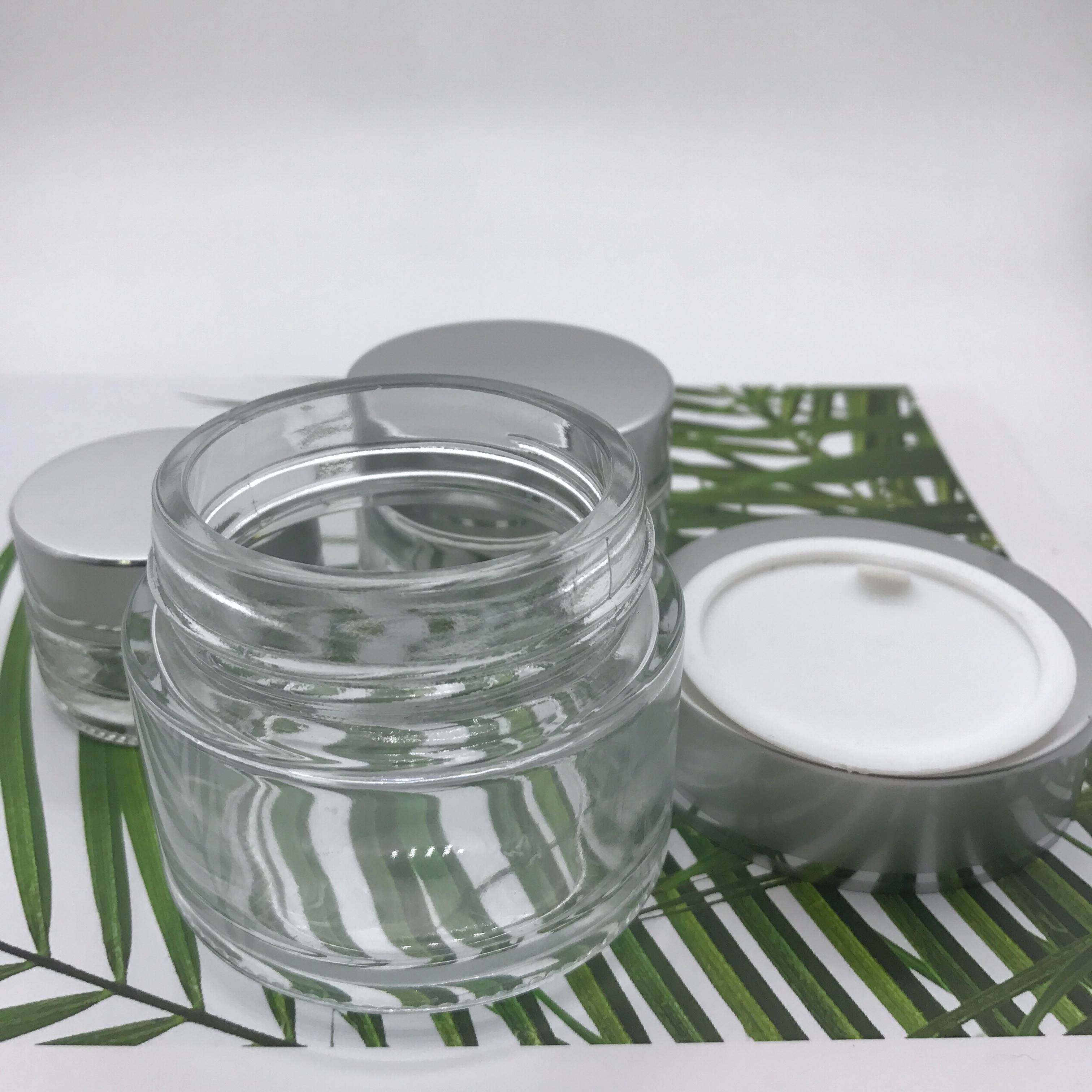 Wholesale empty 20g 30g 50g glass cream jar for cosmetic with silver cap