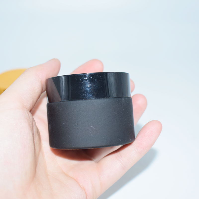 Wholesale frosted matte cosmetic cream glass jar with black cap for facial cosmetic packaging