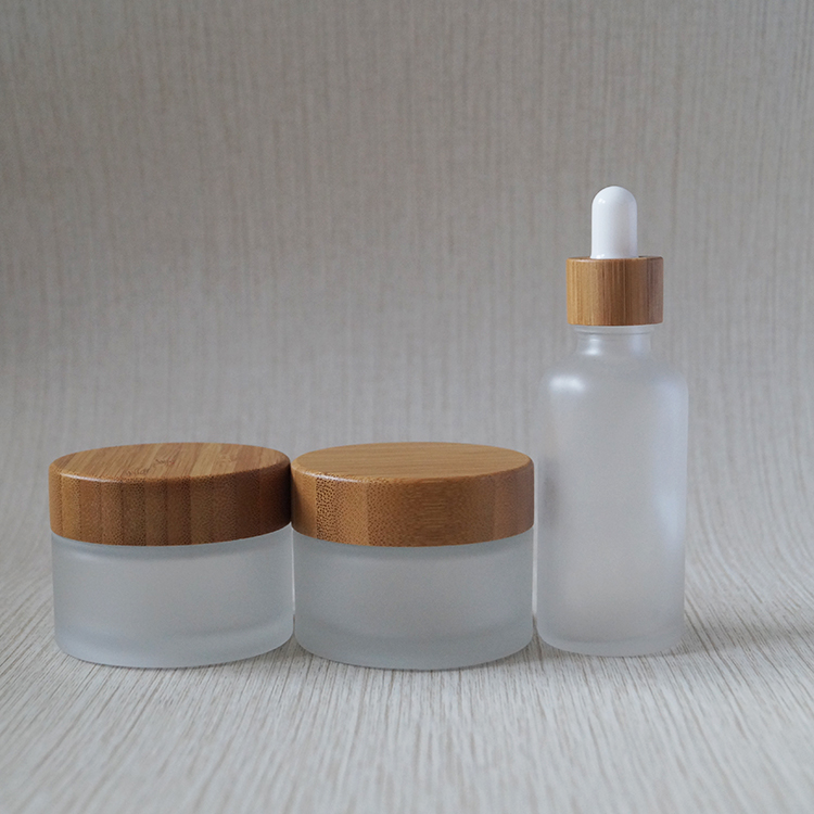 Wholesale new design 30ml 50ml 100ml cosmetic frosted glass jar with bamboo lids
