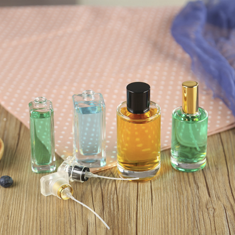 Wholesale round perfume bottle glass bottle and spray head 50ml perfume bottle luxury