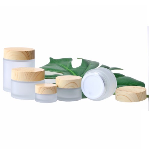 bamboo wood container and skincare packaging frosted glass cream jar