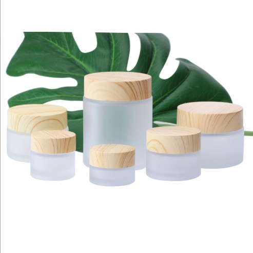 bamboo wood container and skincare packaging frosted glass cream jar