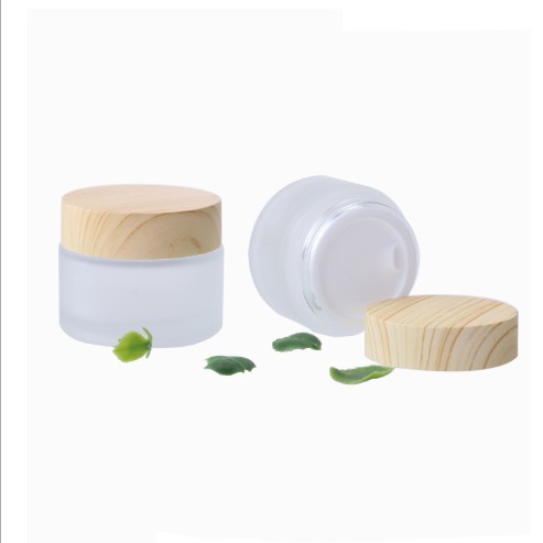 bamboo wood container and skincare packaging frosted glass cream jar