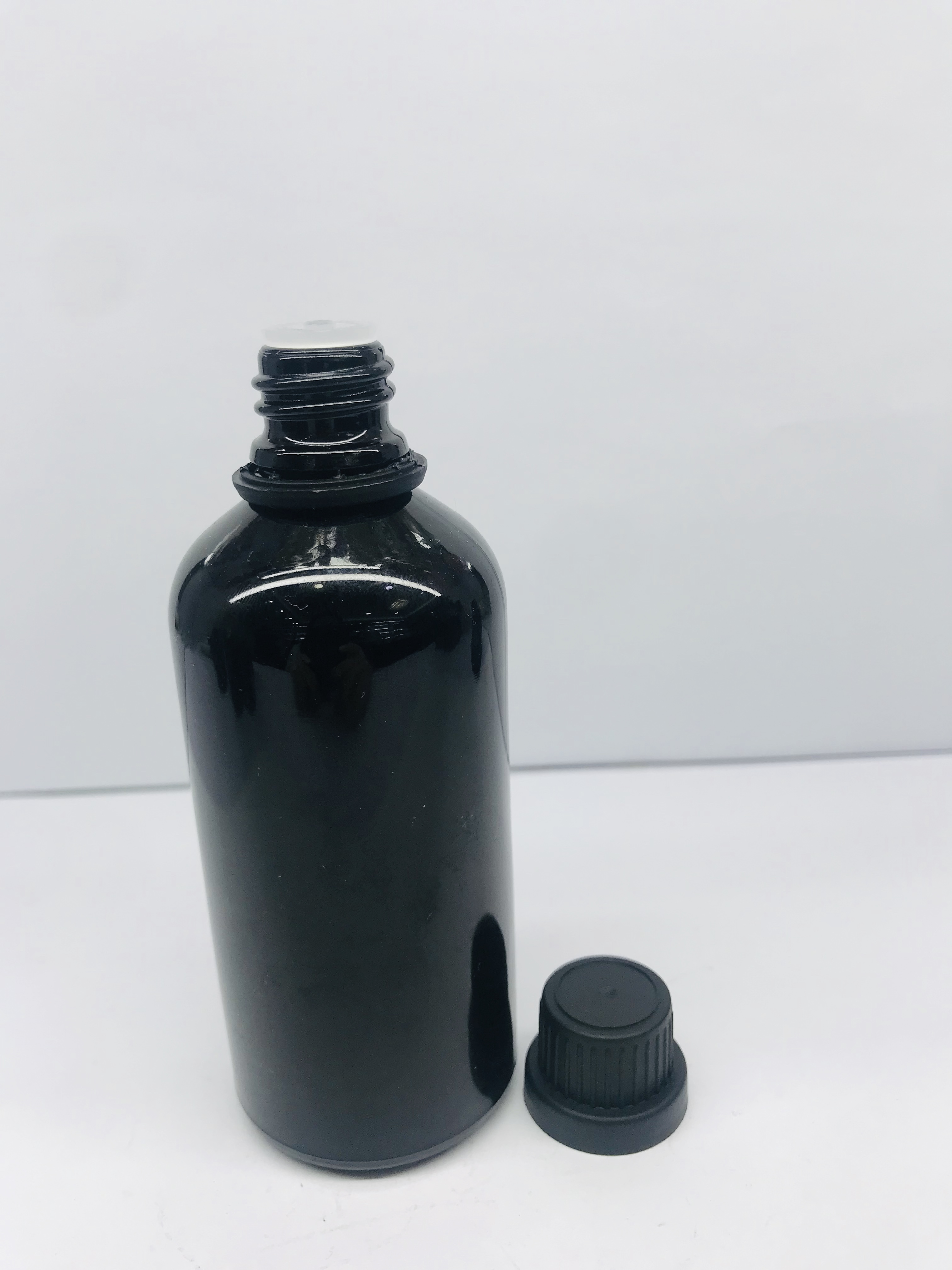 black essential oil glass bottle with black screw cap