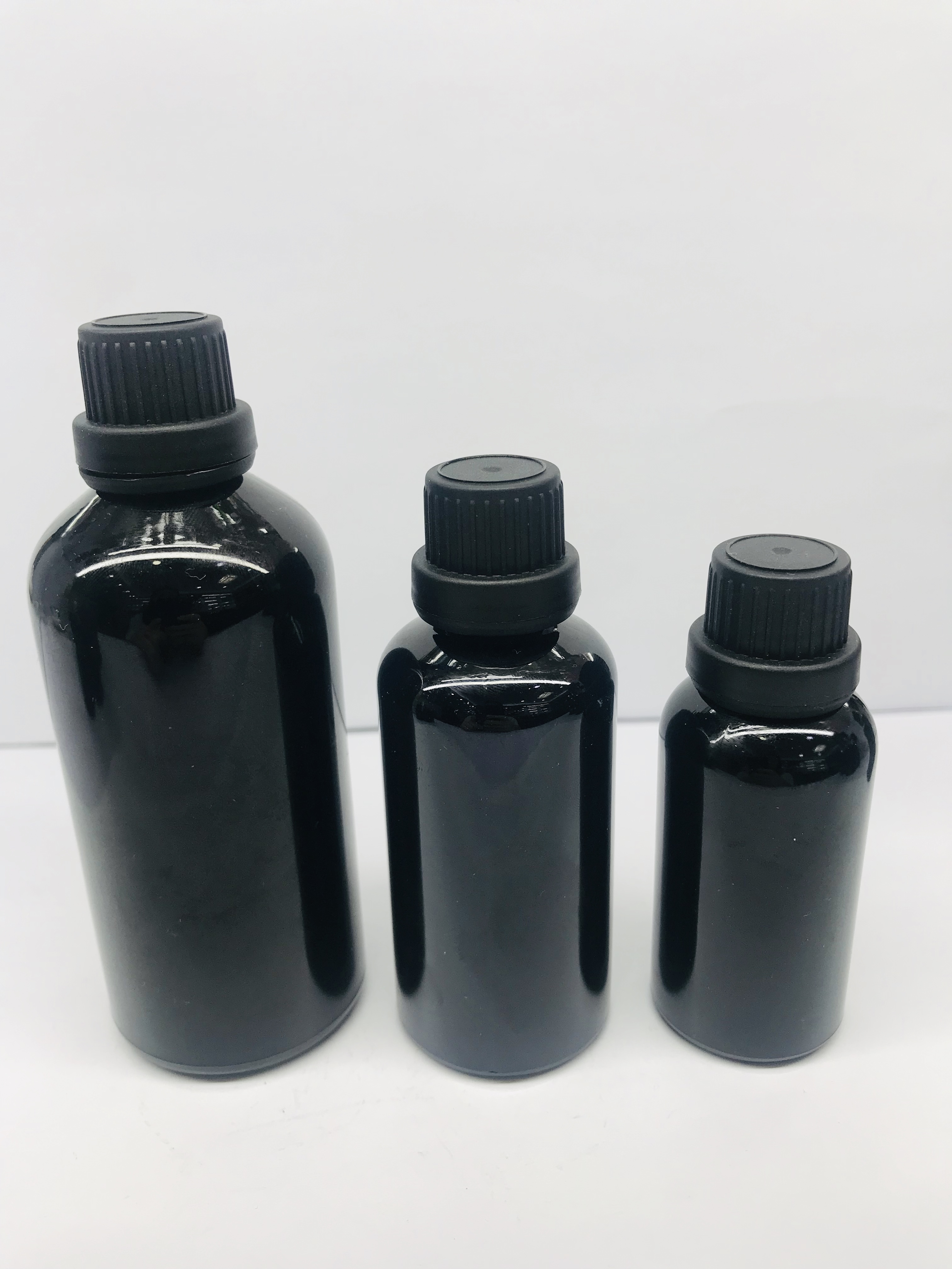 black essential oil glass bottle with black screw cap