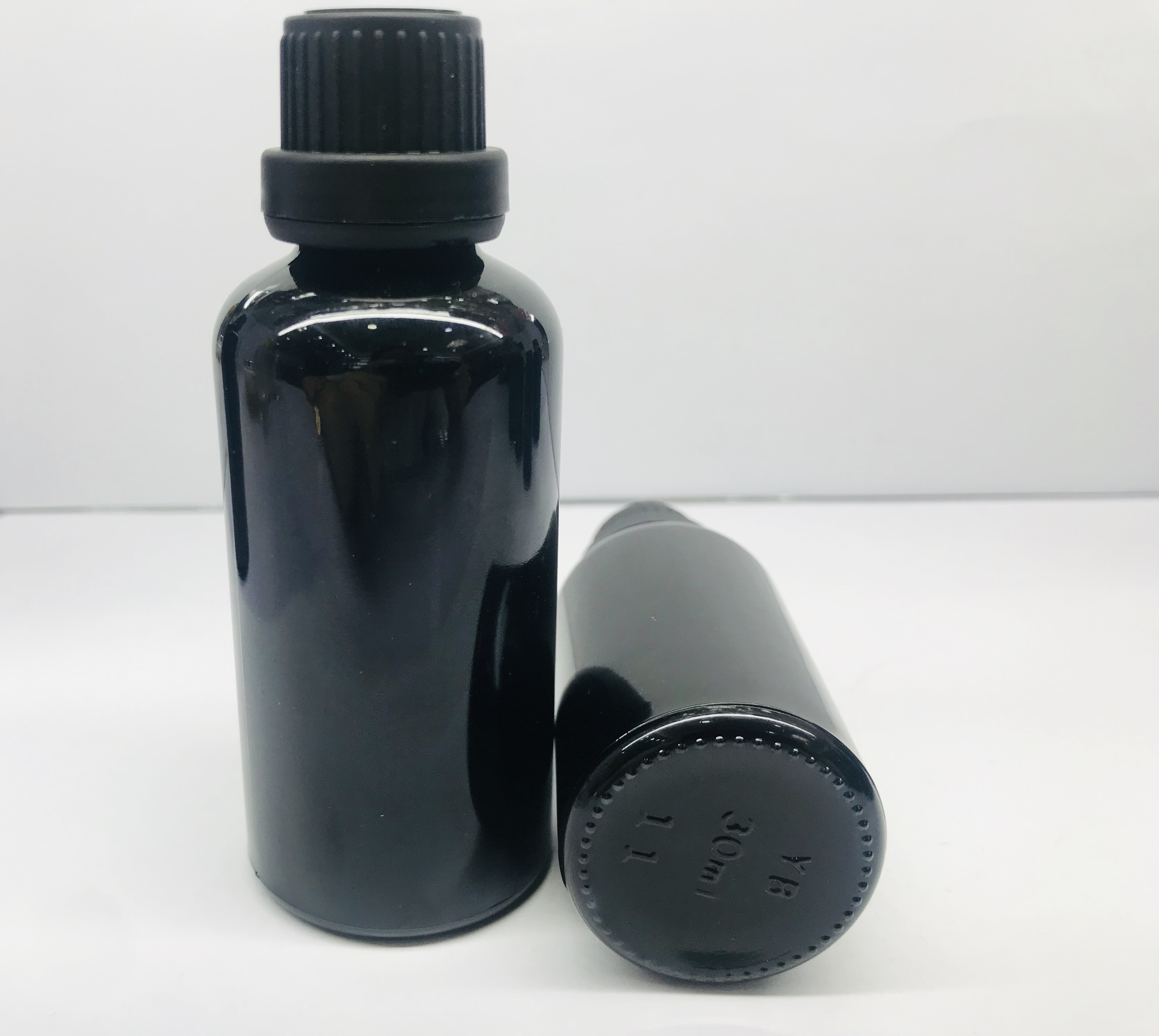 black essential oil glass bottle with black screw cap