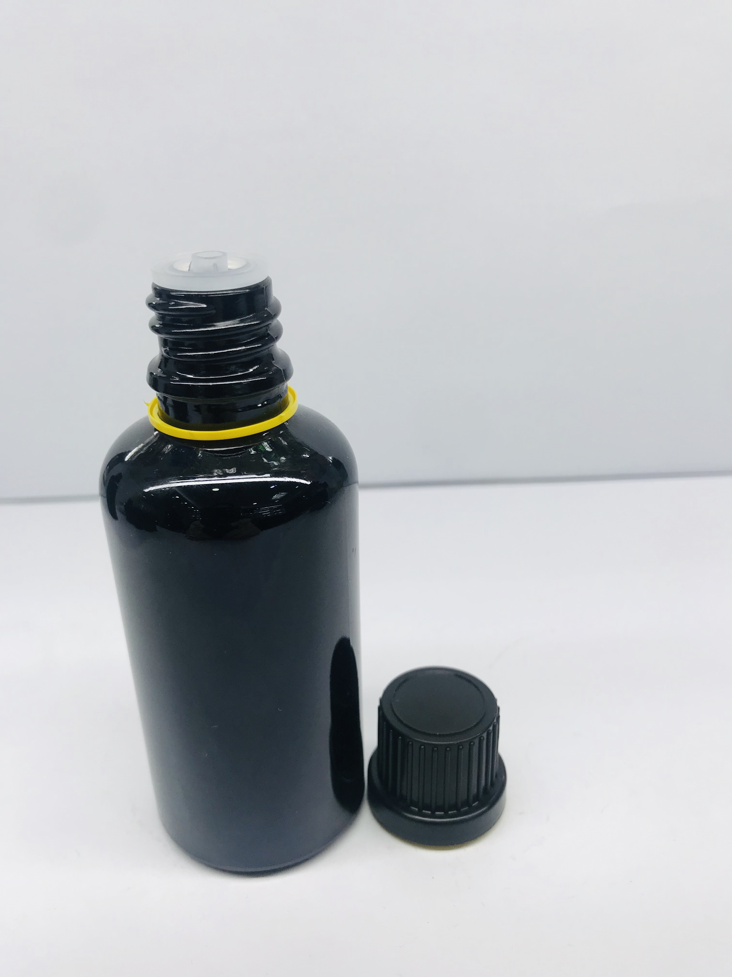black essential oil glass bottle with black screw cap