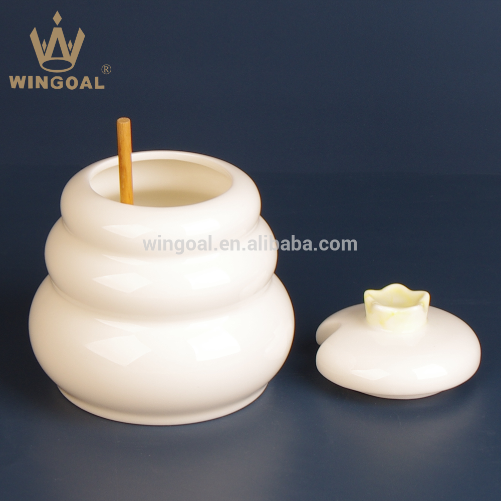 ceramic honey pot with wooden dipper