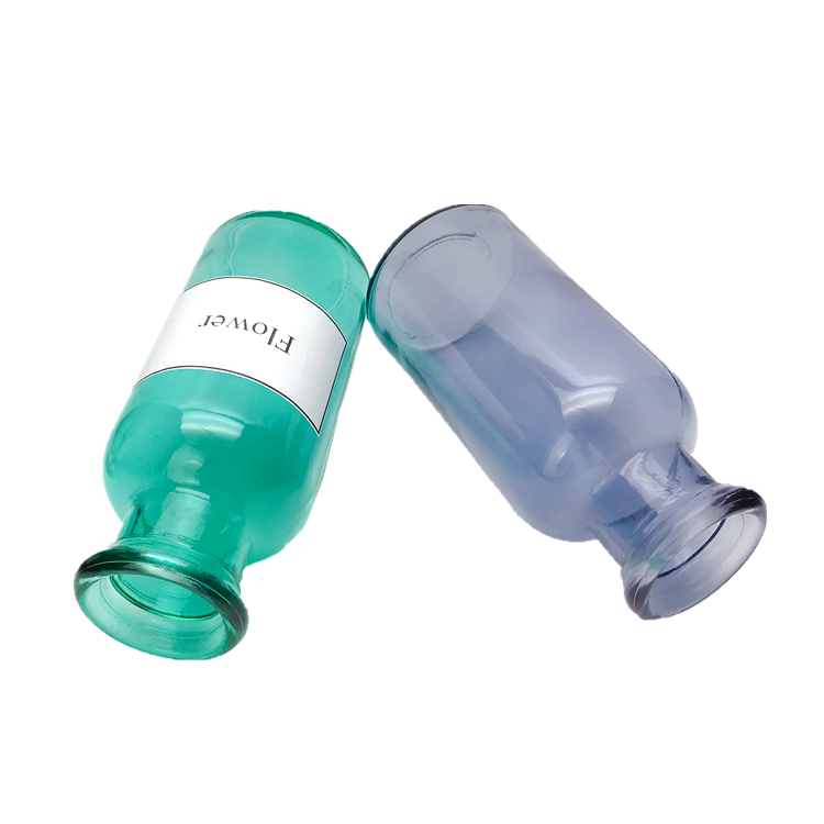 clear colored round glass flower bottle, vase
