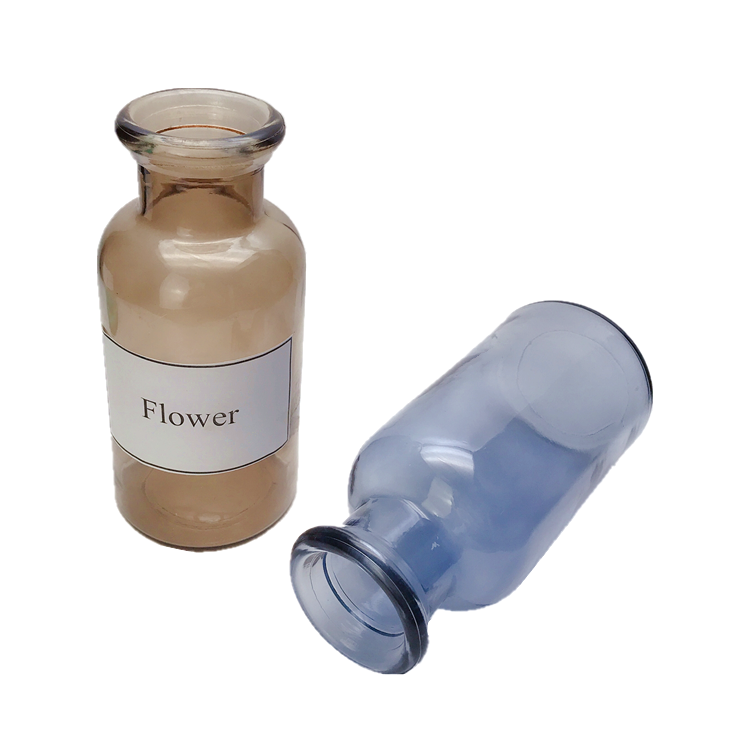 clear colored round glass flower bottle, vase