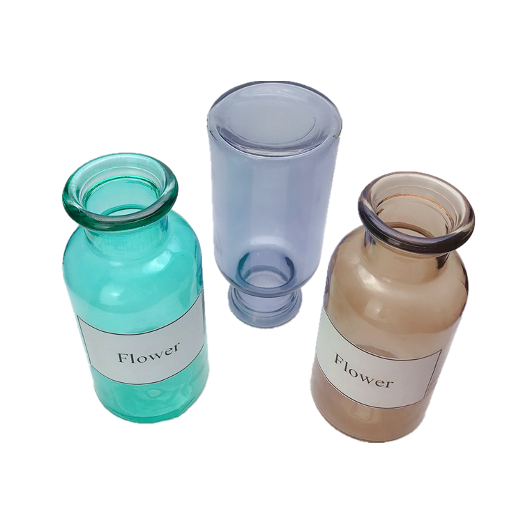 clear colored round glass flower bottle, vase