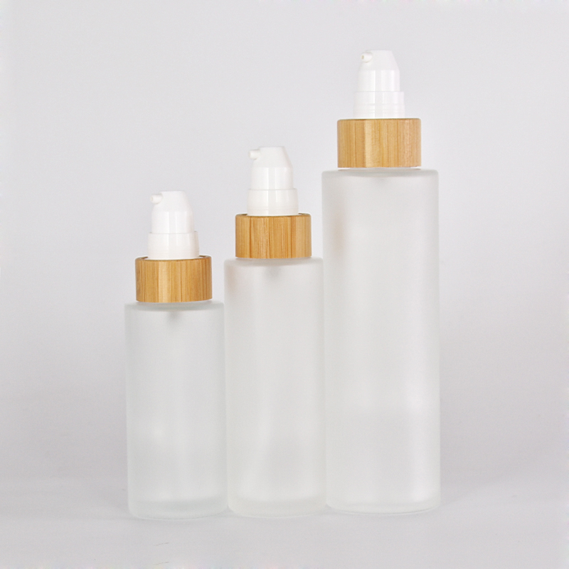 different size customized glass lotion bottle with sprayer pump bamboo collar