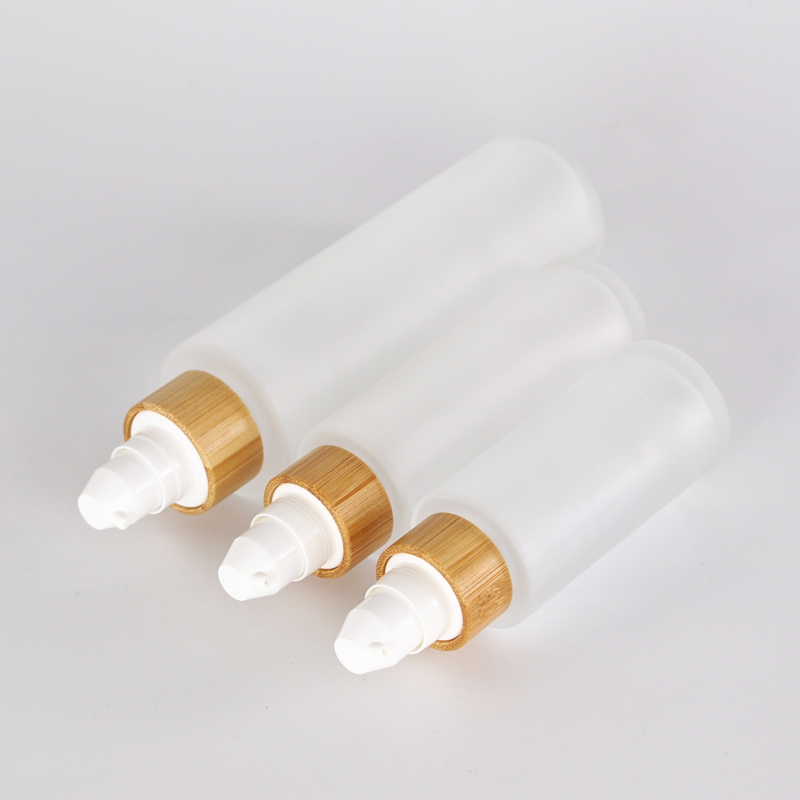 different size customized glass lotion bottle with sprayer pump bamboo collar