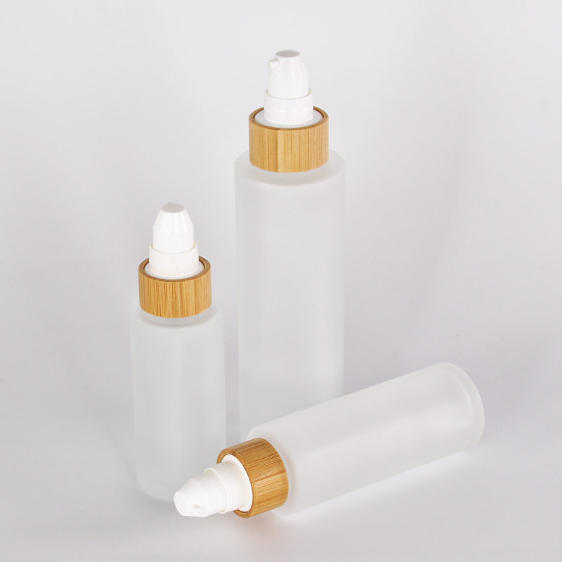different size customized glass lotion bottle with sprayer pump bamboo collar