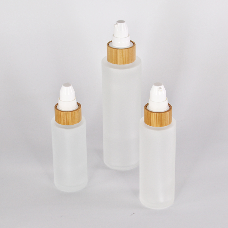 different size customized glass lotion bottle with sprayer pump bamboo collar
