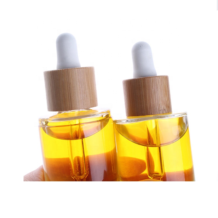 eco friendly round 15ml 30ml 50ml cosmetic clear essential oil bottle glass dropper bottle with dropper bamboo lid