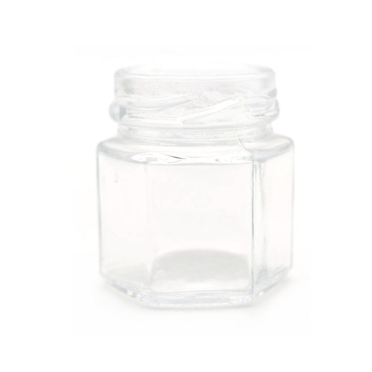 elegant glass 6-faceted tiny jars with white lug-style lids