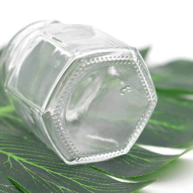 elegant glass 6-faceted tiny jars with white lug-style lids