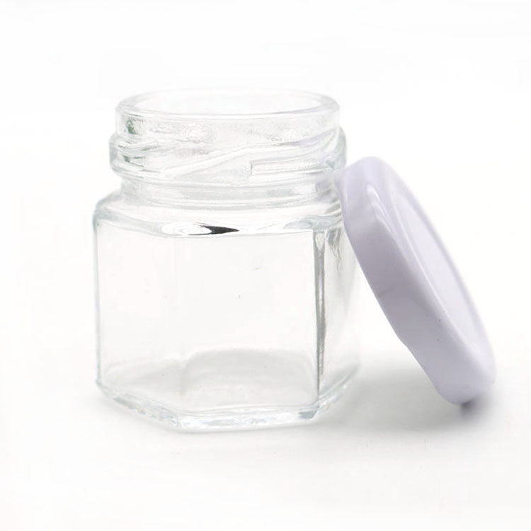 elegant glass 6-faceted tiny jars with white lug-style lids