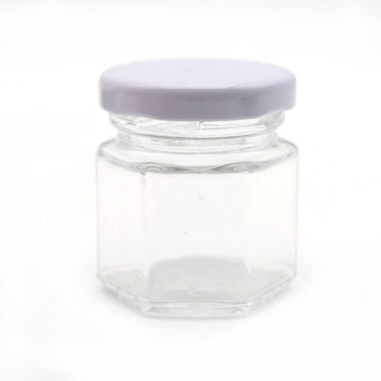 elegant glass 6-faceted tiny jars with white lug-style lids
