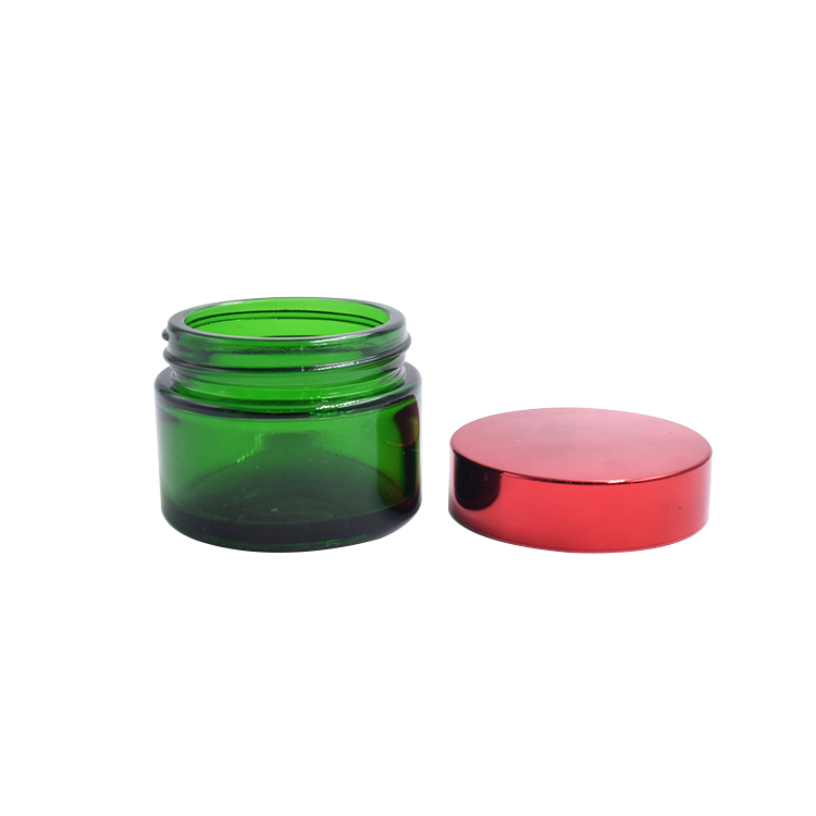 empty green glass container metal lid cosmetic cream lotion body scrub glass jar
