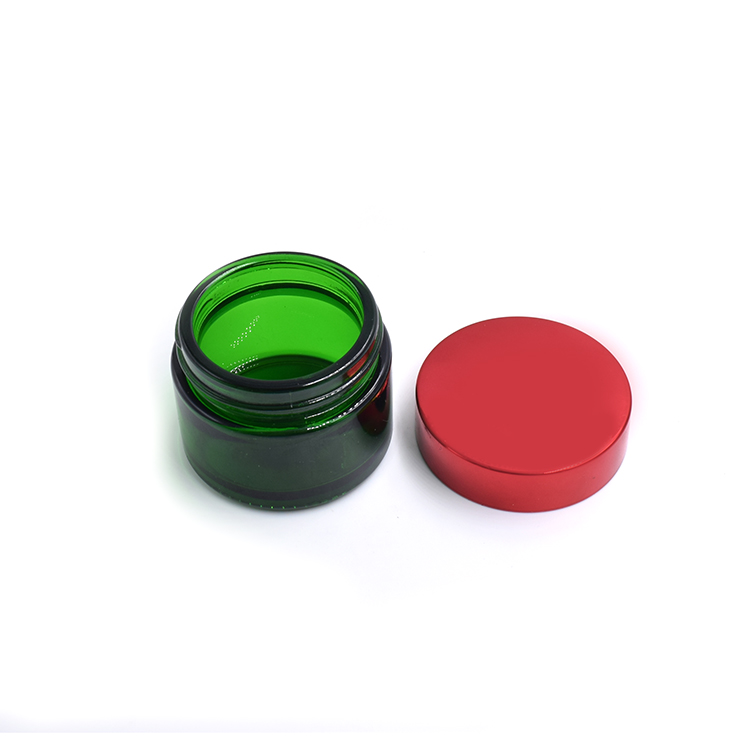 empty green glass container metal lid cosmetic cream lotion body scrub glass jar