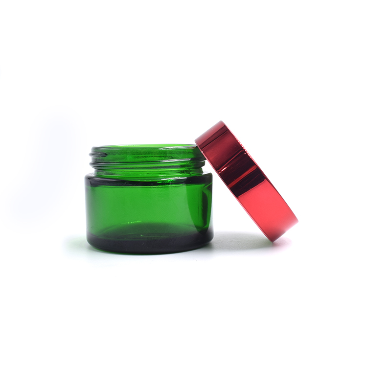 empty green glass container metal lid cosmetic cream lotion body scrub glass jar