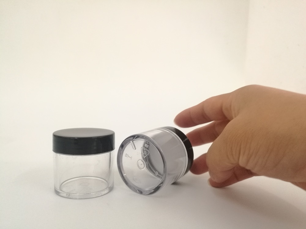 empty plastic 30g jar with black lid