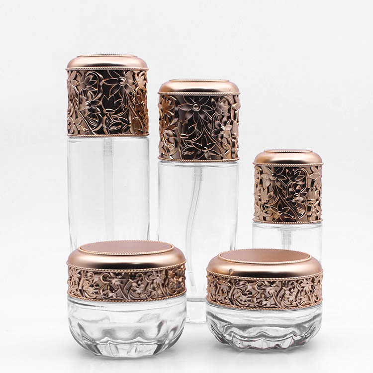 fancy clear empty glass bottle jar with plastic golden emboss lid cosmetic glass jar with screw top lid makeup set bottles