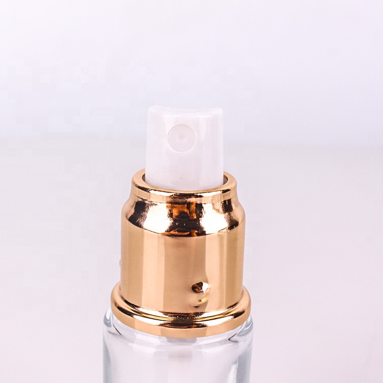 high end cosmetic packing 1oz clear glass lotion bottle with gold metal lotion pump