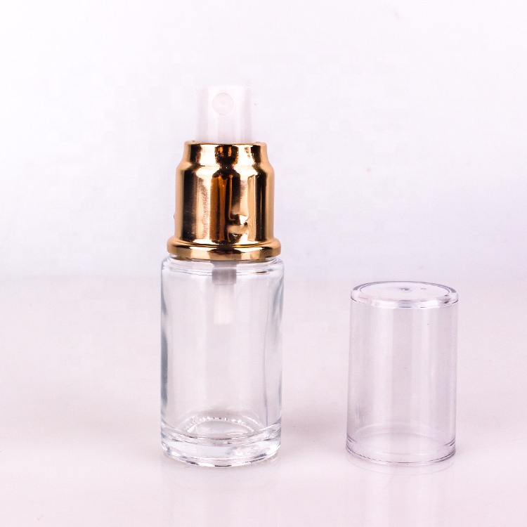 high end cosmetic packing 1oz clear glass lotion bottle with gold metal lotion pump