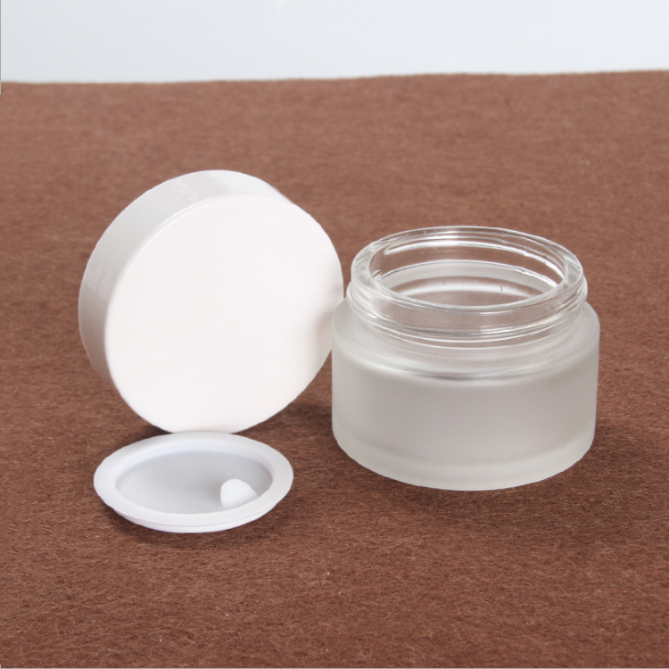 high quality 30 ml 1oz clear frosted cosmetic packaging glass jar with white black plastic cap for skin care cream