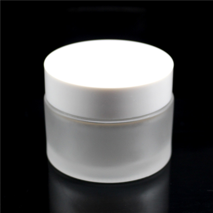 high quality 30 ml 1oz clear frosted cosmetic packaging glass jar with white black plastic cap for skin care cream