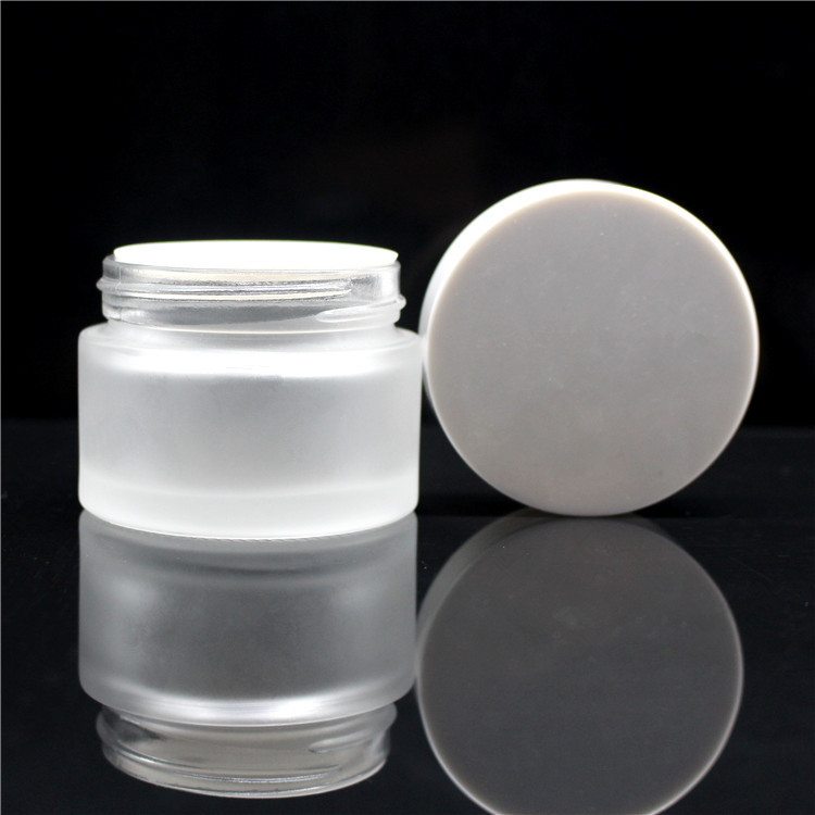 high quality 30 ml 1oz clear frosted cosmetic packaging glass jar with white black plastic cap for skin care cream
