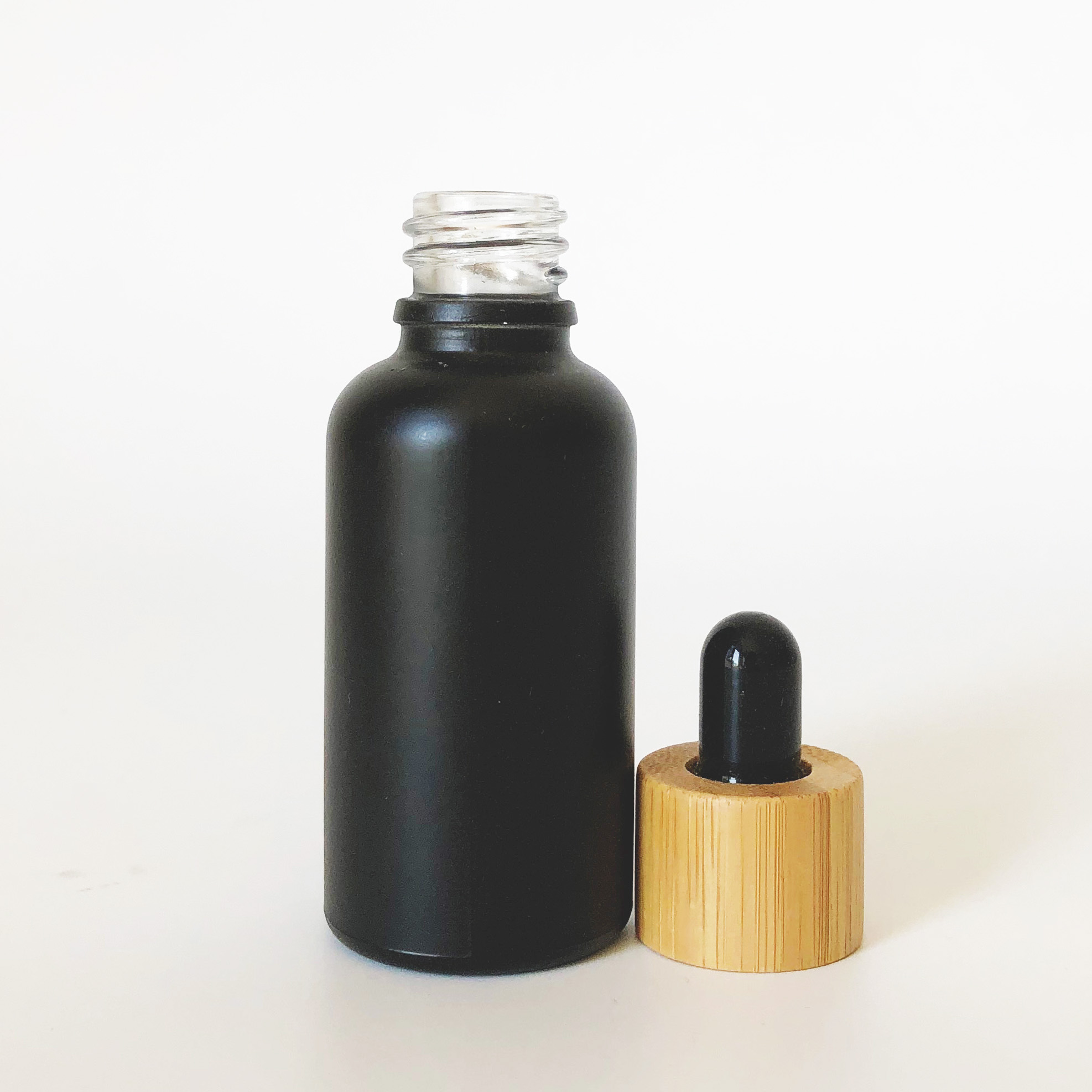 high quality 30ml black frosted glass bottle wholesale 1oz glass bottle bamboo cap