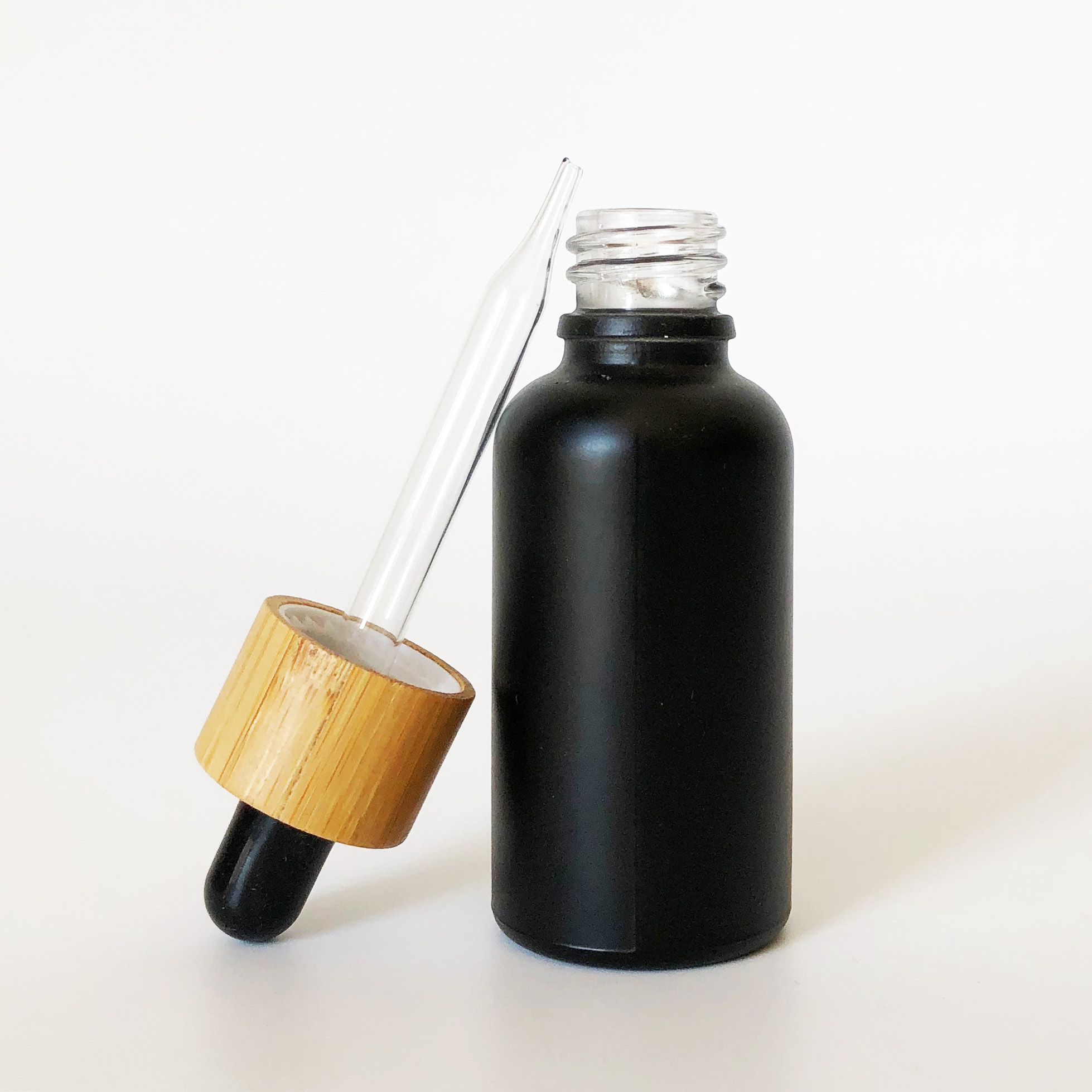 high quality 30ml black frosted glass bottle wholesale 1oz glass bottle bamboo cap