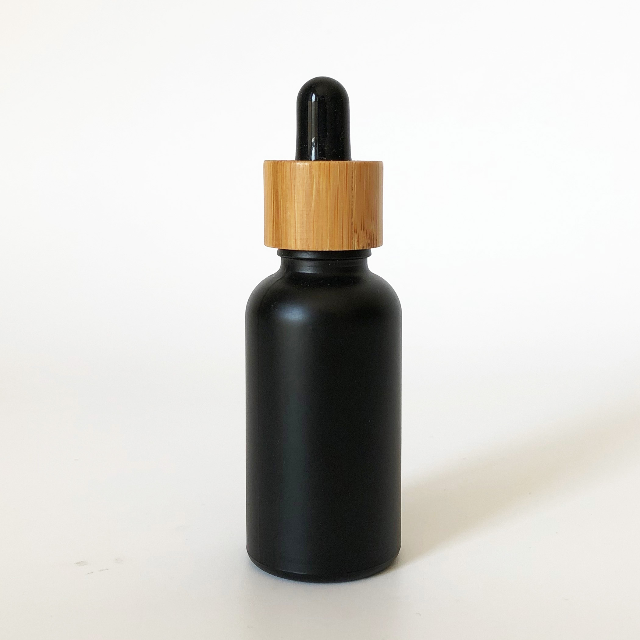 high quality 30ml black frosted glass bottle wholesale 1oz glass bottle bamboo cap
