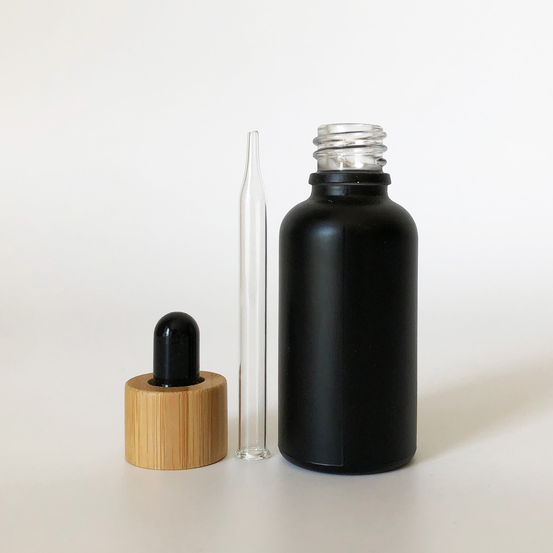 high quality 30ml black frosted glass bottle wholesale 1oz glass bottle bamboo cap